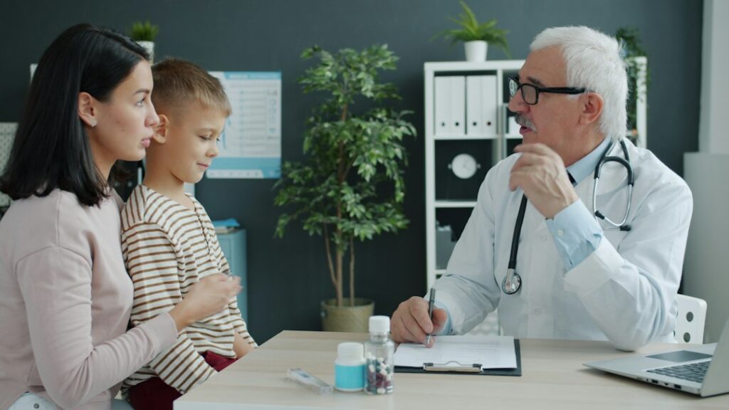Parent and child reviewing a puberty growth chart together at a kitchen table.