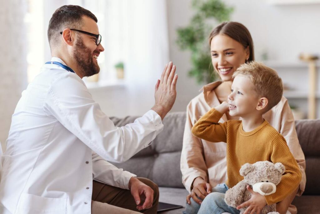Parent and child sit together in a quiet room while the child responds to a spoken question.